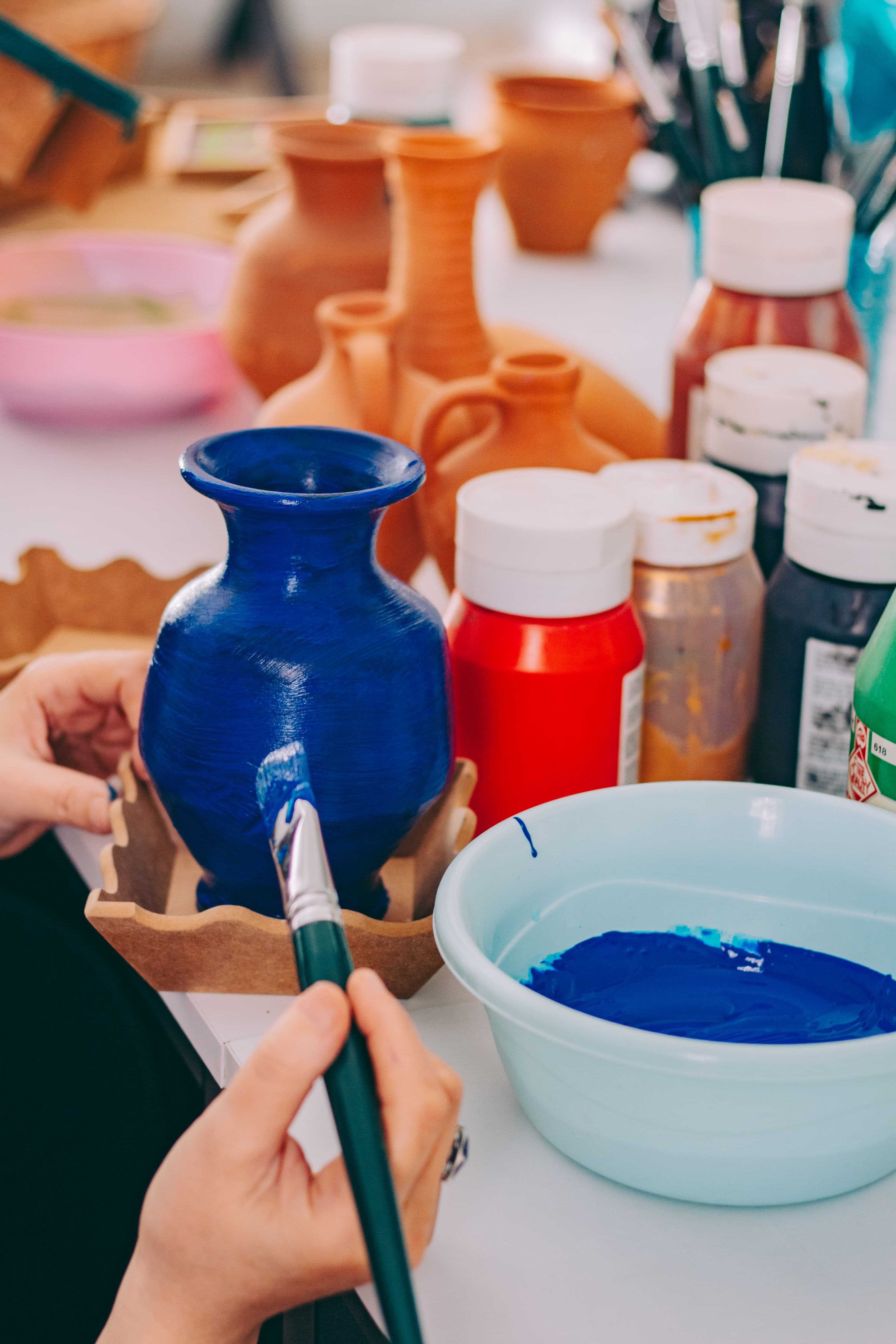 Paints, brushes and sketching materials on a studio desk